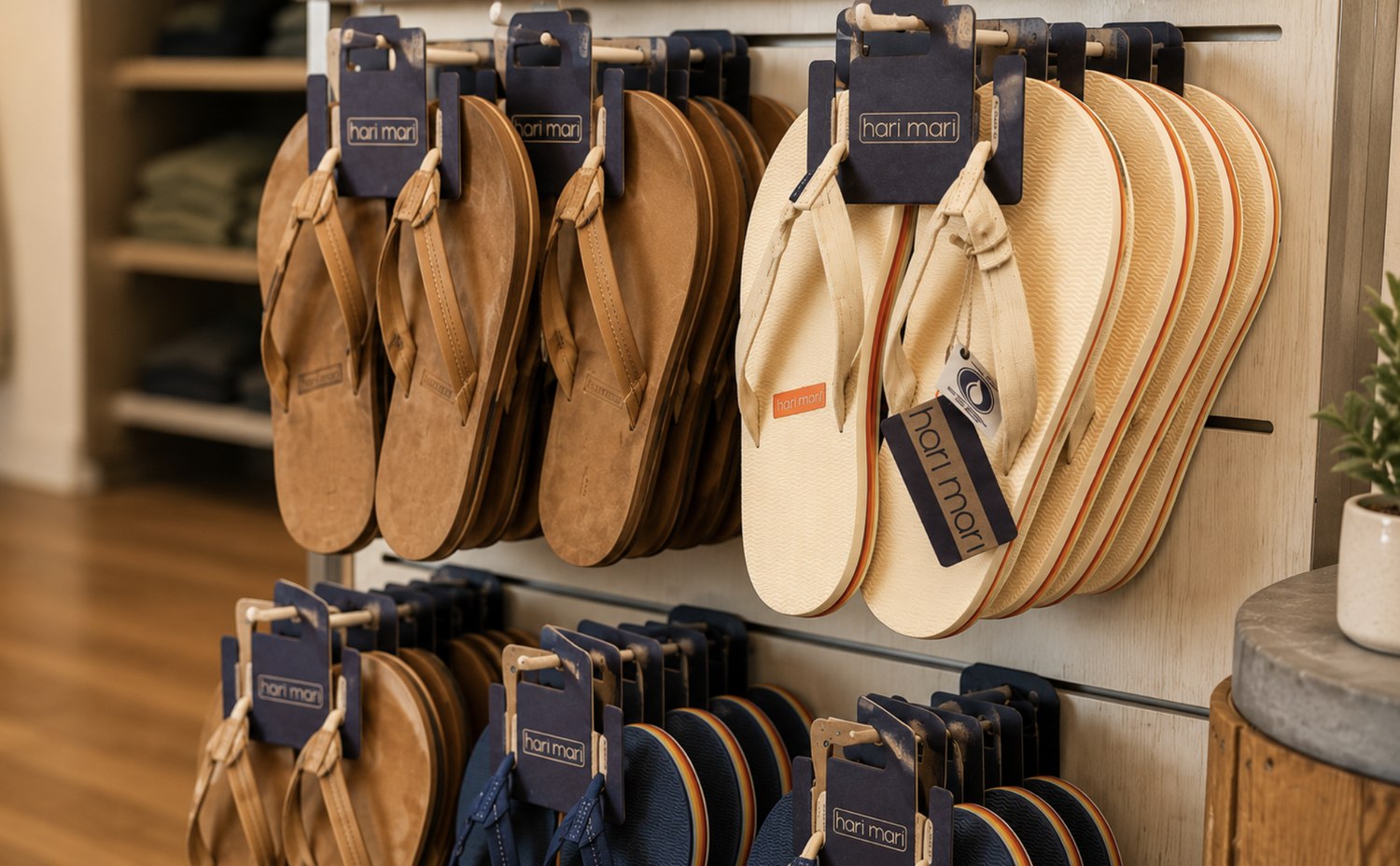 Hari Mari leather and canvas flip-flops on a shop wall rack