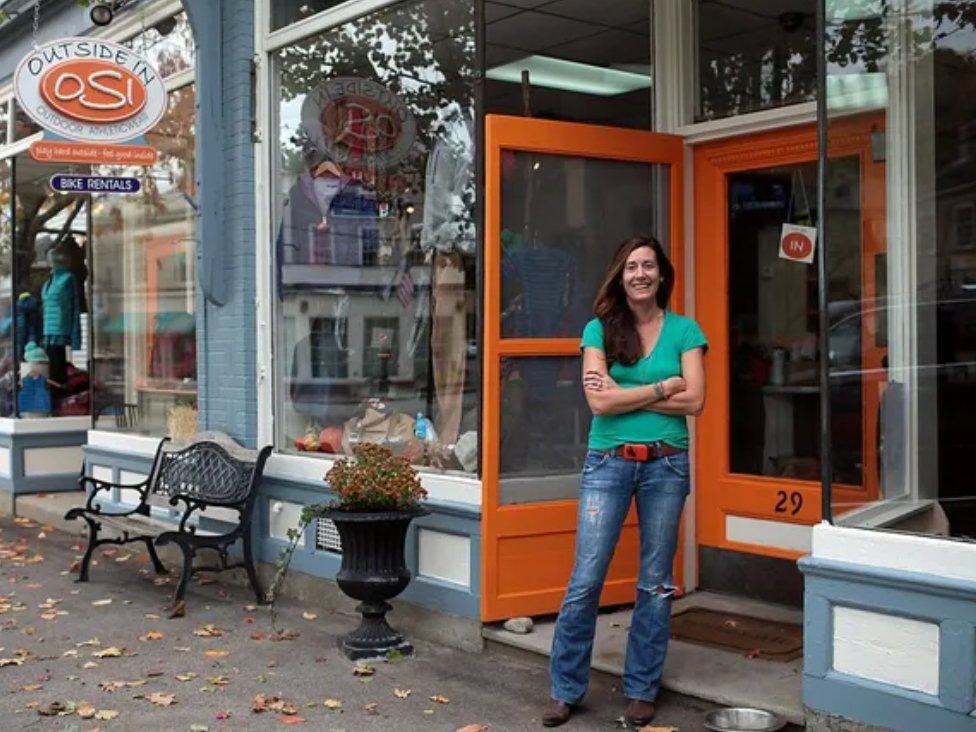 Owner standing outside the Outside In storefront in Cohasset