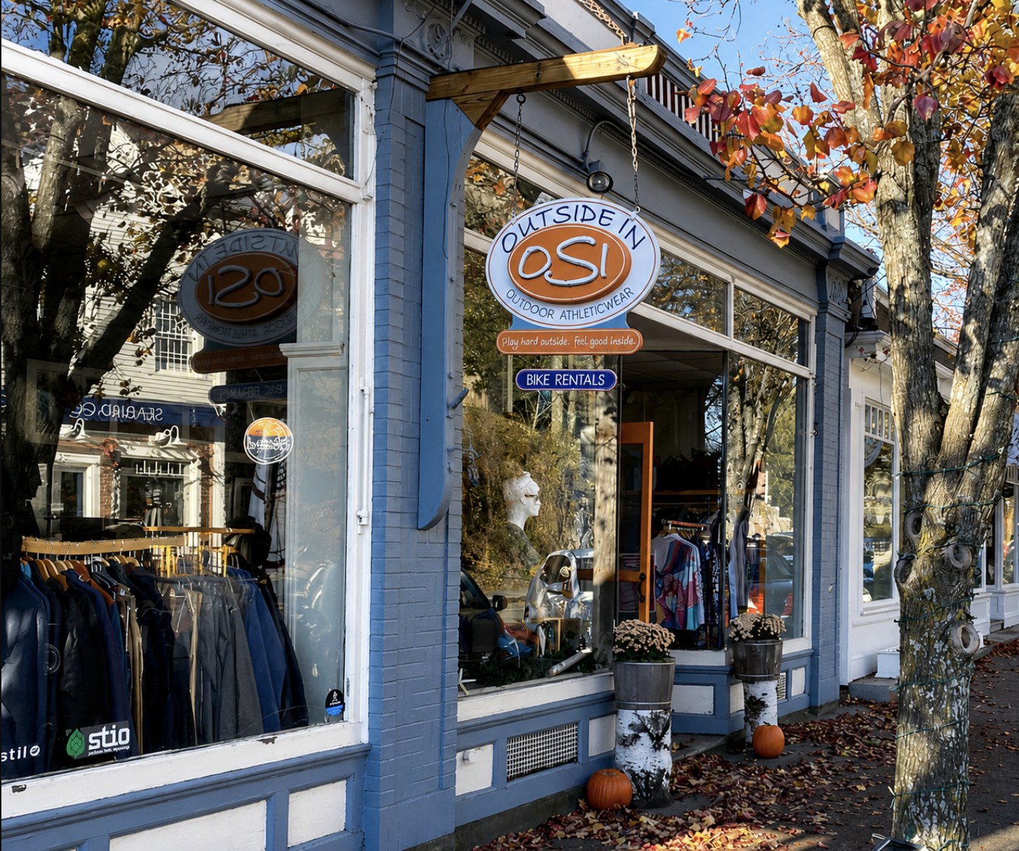 The Outside In storefront on South Main Street in Cohasset, with its OSI sign, bike-rentals board and autumn foliage